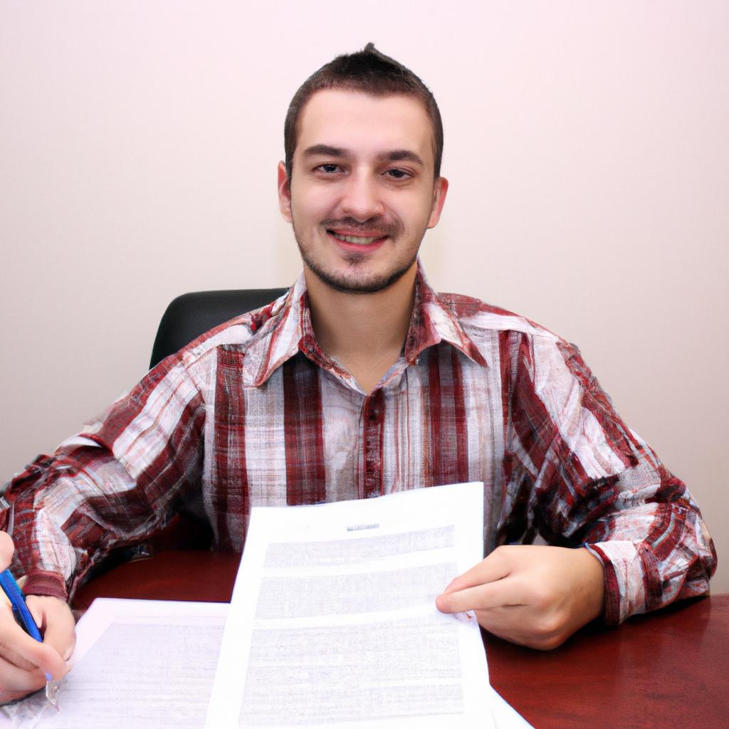 Person signing financial documents, smiling